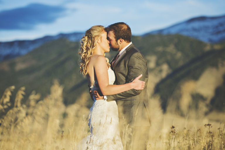 wedding photography of bride and groom dancing outside in a field after the ceremony