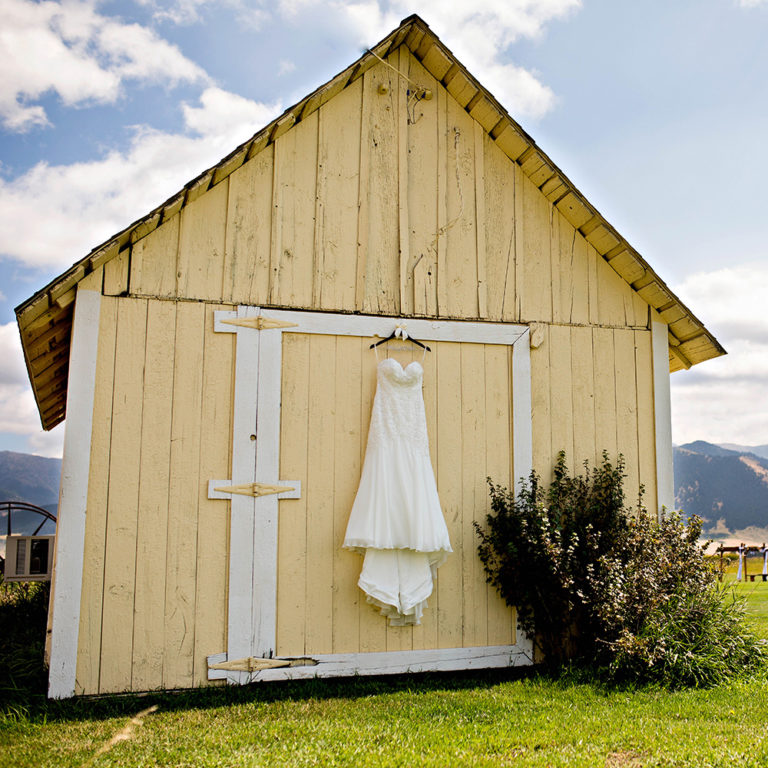 engagement photography of the bridge and groom to be bundled up in a blanket outside in a field