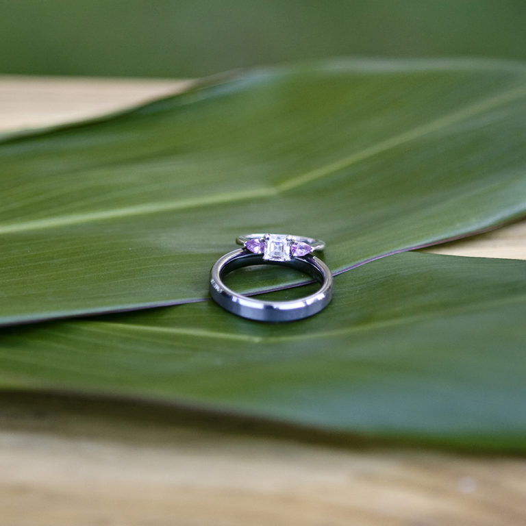 engagement photography of the bridge and groom to be bundled up in a blanket outside in a field