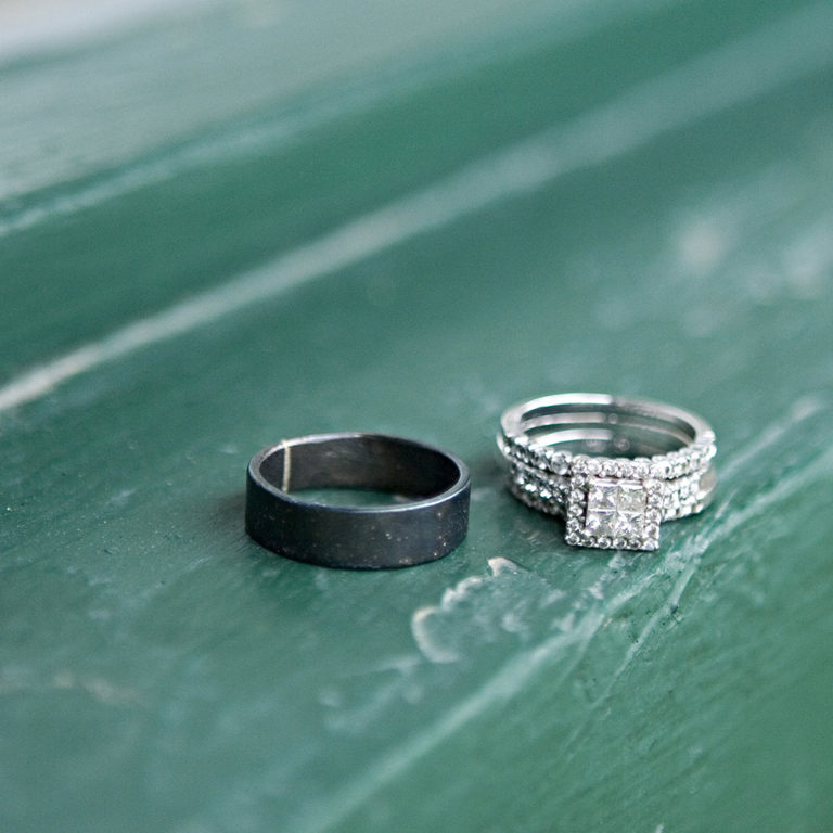 engagement photography of the bridge and groom to be bundled up in a blanket outside in a field