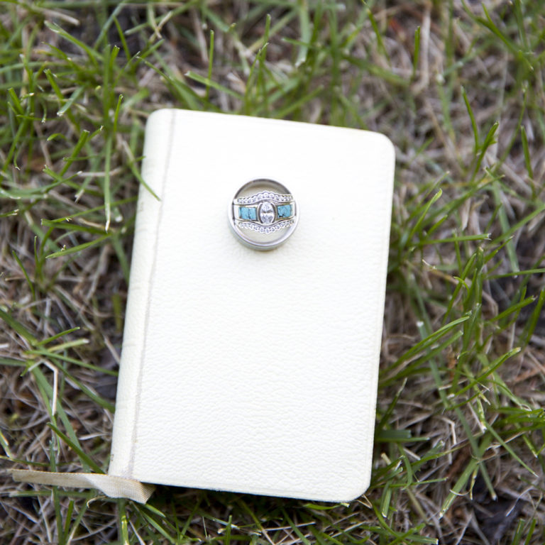 engagement photography of the bridge and groom to be bundled up in a blanket outside in a field