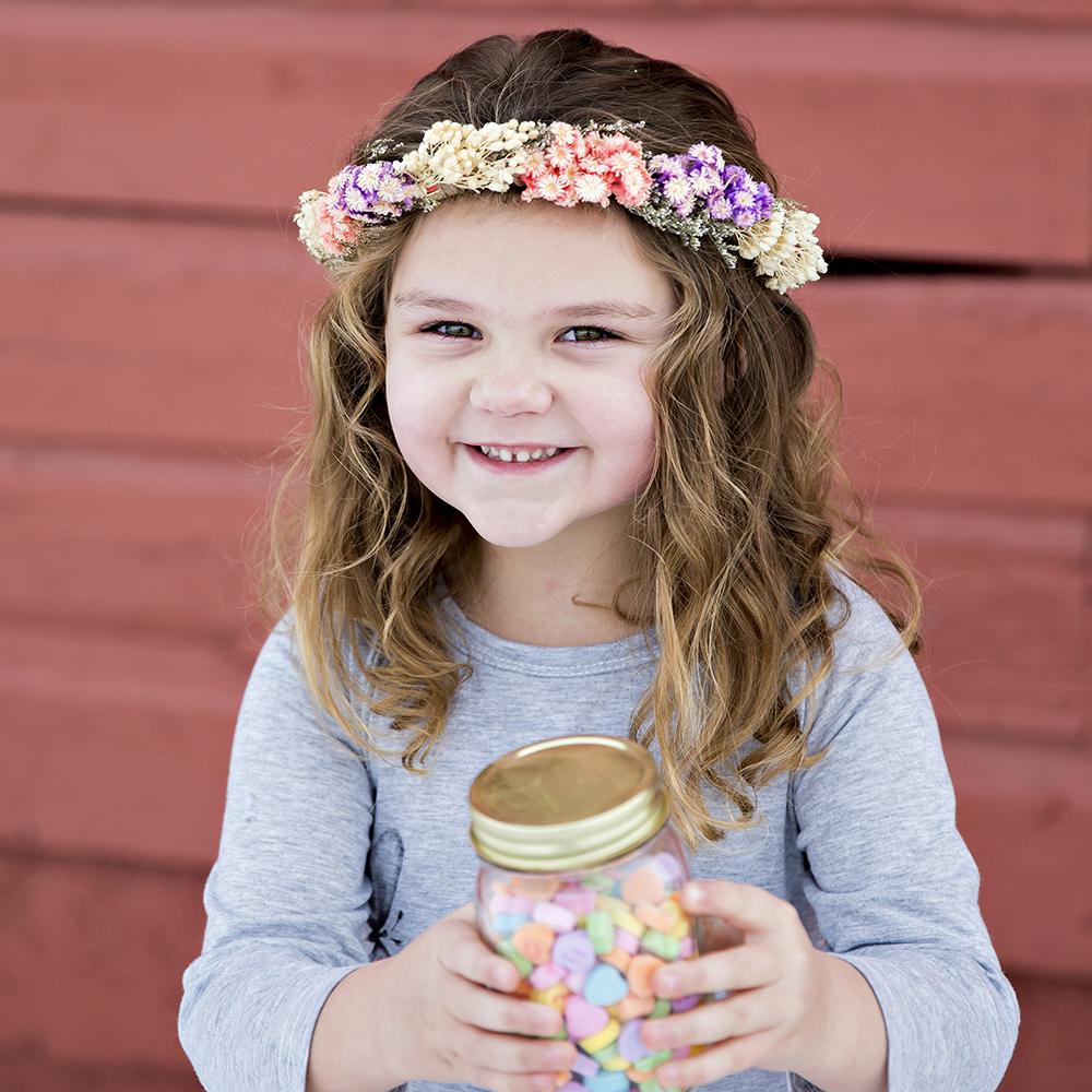 holiday portrait photography of two young sisters dressed for the holidays outside surrounded by decorations