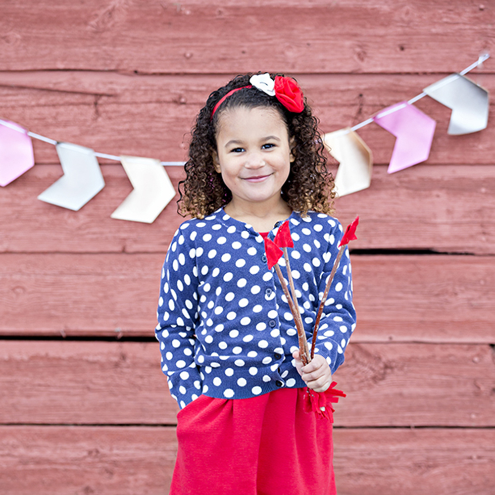 holiday portrait photography of two young sisters dressed for the holidays outside surrounded by decorations