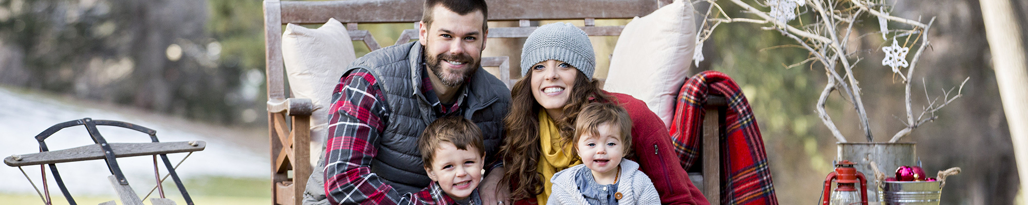 holiday portrait photography of a mother, father, and their two children dressed for the holidays outside