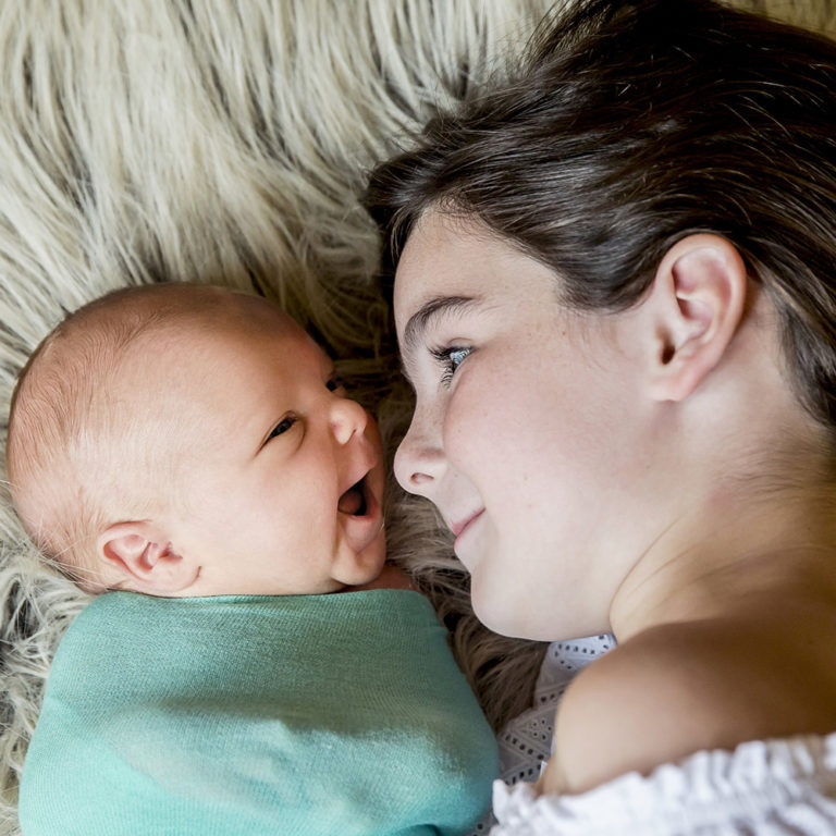 newborn photography of a newborn baby sleeping wrapped in a blanket