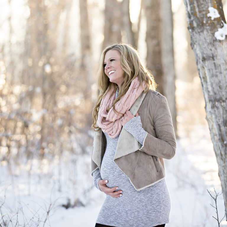 newborn photography of a new father smiling down at his newborn baby yawning in his arms