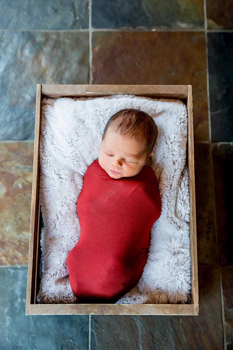 newborn photography of a newborn baby sleeping wrapped in a blanket
