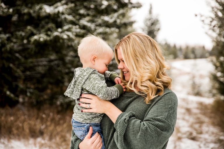 pregnant mom looks at her son at Kirk Hill in Bozeman