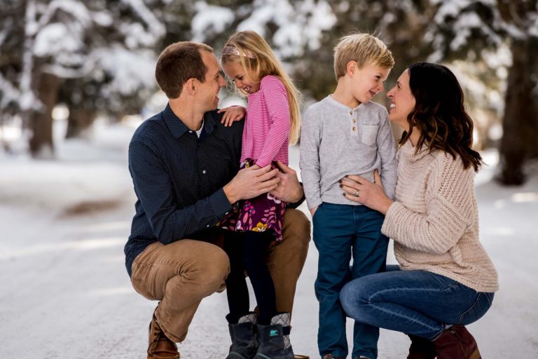 mom, dad, son and daughter in the snow at Lindley Park , Bozeman