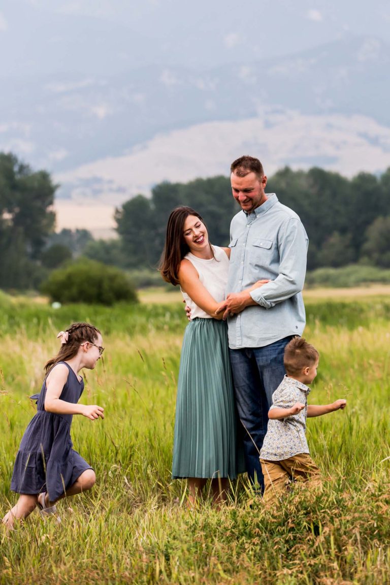 family portrait photography of a baby girl walking on a pebble path