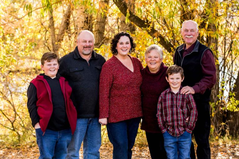 parents, kids and grandparents pose for multi-generational portrait