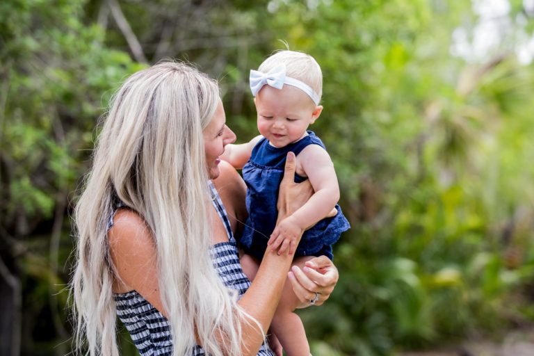 Mom holding and looking at baby daughter