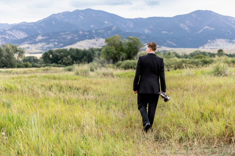 newborn photography of a newborn baby curled up sleeping on a white blanket