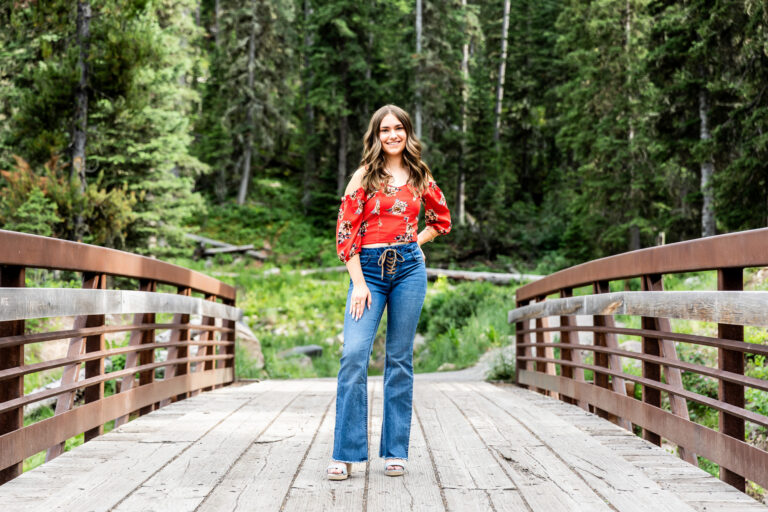 newborn photography of a new father smiling down at his newborn baby yawning in his arms